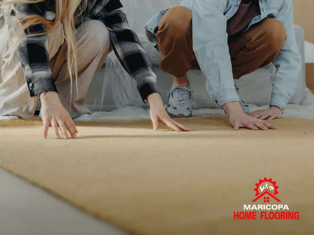 Couple installing new flooring as part of a carpet replacement project