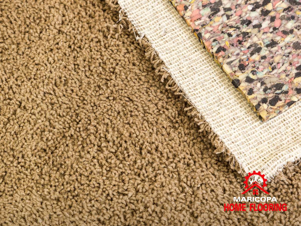 carpet padding under a brown carpet, showing layers for comfort and durability – Maricopa Home Flooring